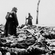 Death (far left) watches as WWI German soldiers wade through mounds of fallen French infantrymen to make sure none are still alive.